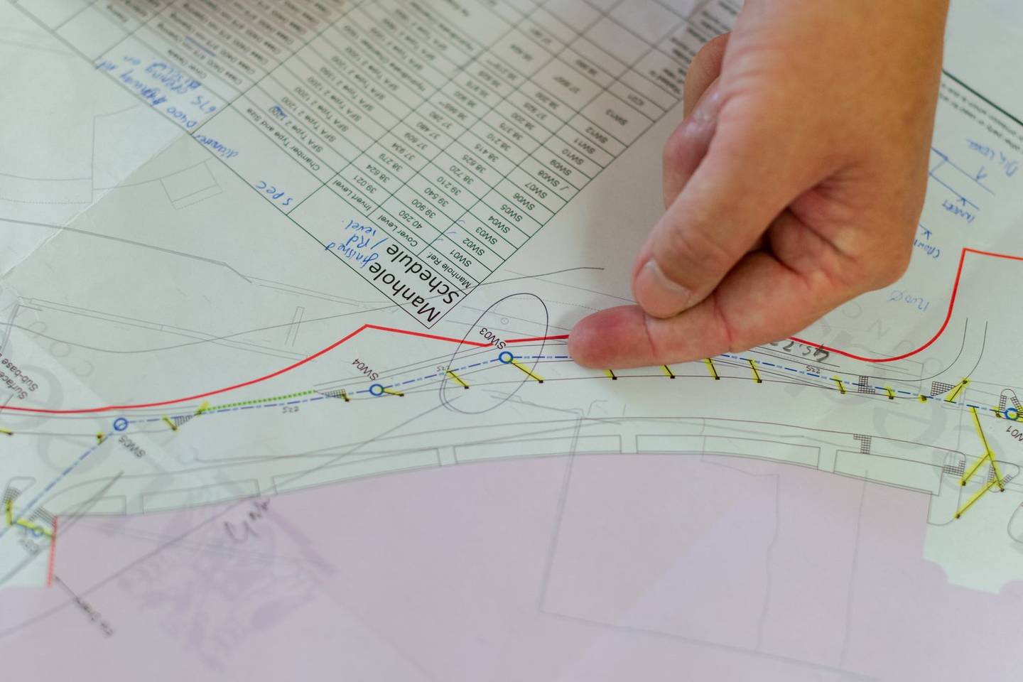 Planning a commercial paving project schedule on blueprints