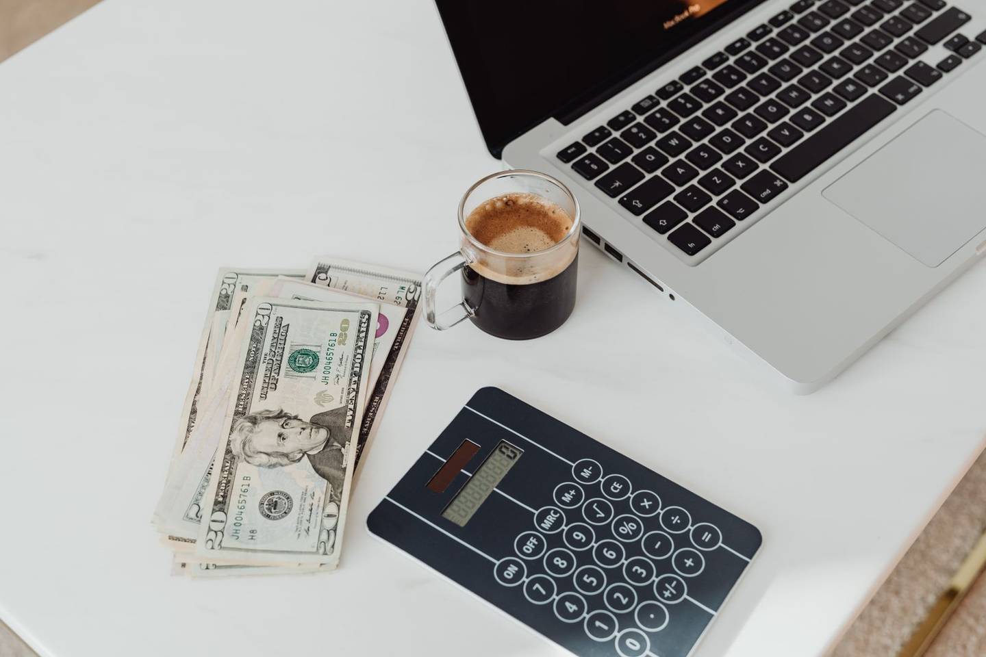 Calculator and paperwork for estimating asphalt paving cost