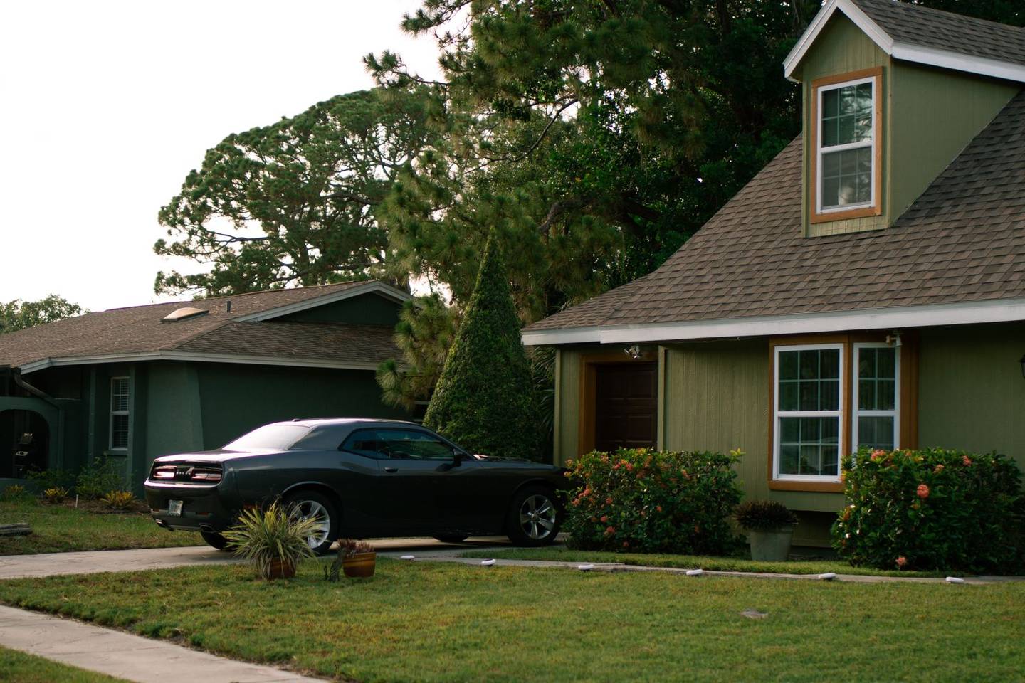 Suburban home with an asphalt driveway at dusk