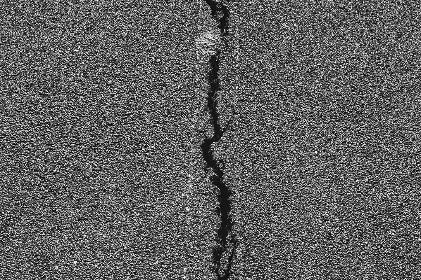 Cracked asphalt creating a trip-and-fall liability hazard